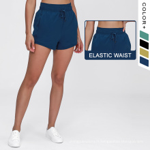 Shorts de course pour femmes couleurs de couleur unie à crampon de la taille élastique du yoga élastique short de yoga respirant avec des poches